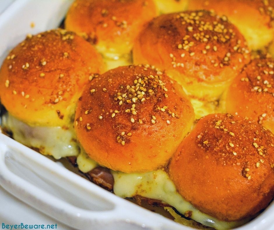 Roast beef Hawaiian roll sliders, or more affectionately called Sandy's Sandwiches, combine butter, garlic powder, Worcestershire sauce, and poppy seeds for a butter glaze that compliments these baked roast beef and cheese sandwiches.