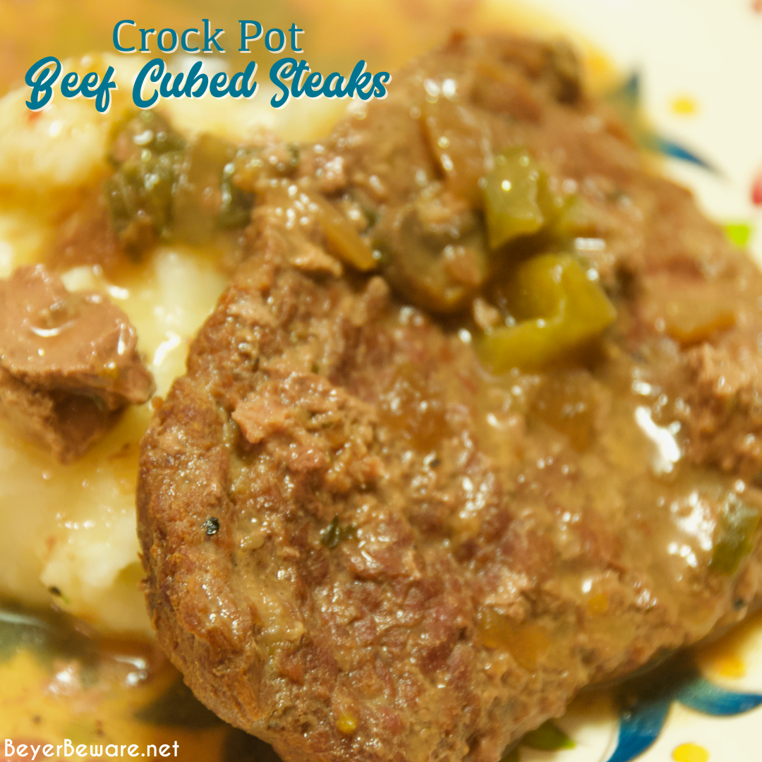 Crock pot beef cubed steak with gravy is a simple recipe that combines ranch and Italian seasoning and cream of mushroom soup and French onion soup with mushrooms, onions, and peppers for a tender cubed steak recipe that is perfect over mashed potatoes.