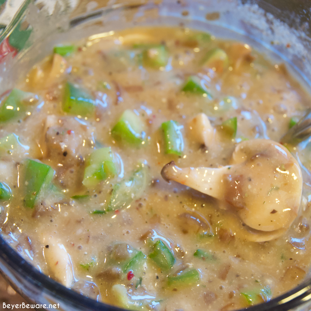 Crock pot beef cubed steak with gravy is a simple recipe that combines ranch and Italian seasoning and cream of mushroom soup and French onion soup with mushrooms, onions, and peppers for a tender cubed steak recipe that is perfect over mashed potatoes.