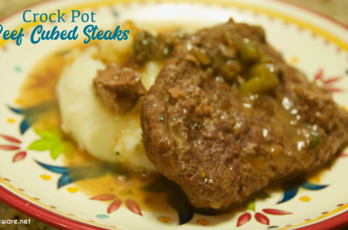 Crock pot beef cubed steak with gravy is a simple recipe that combines ranch and Italian seasoning and cream of mushroom soup and French onion soup with mushrooms, onions, and peppers for a tender cubed steak recipe that is perfect over mashed potatoes.