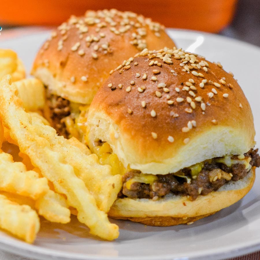 Hawaiian roll hamburger sliders recipe is a loose meat cheeseburger sliders pan fried with onion soup mix and mayonnaise then baked on the butter topped rolls with lots of cheese.