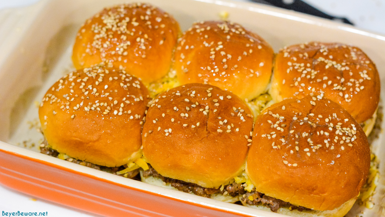 Hawaiian roll hamburger sliders recipe is a loose meat cheeseburger sliders pan fried with onion soup mix and mayonnaise then baked on the butter topped rolls with lots of cheese.