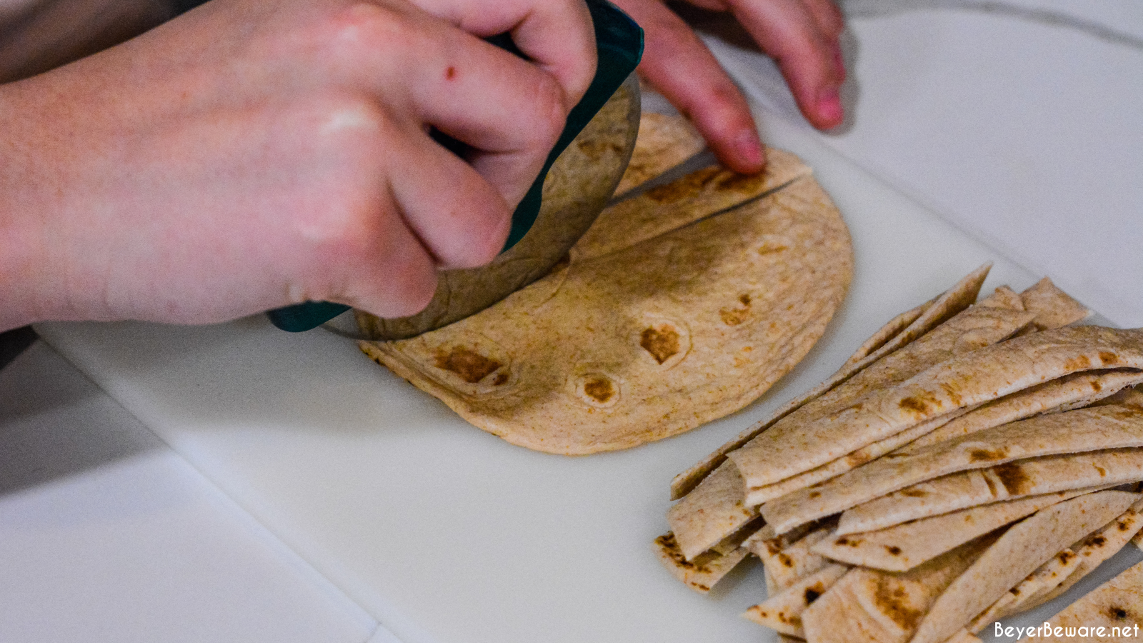 Cutting tortillas into strips