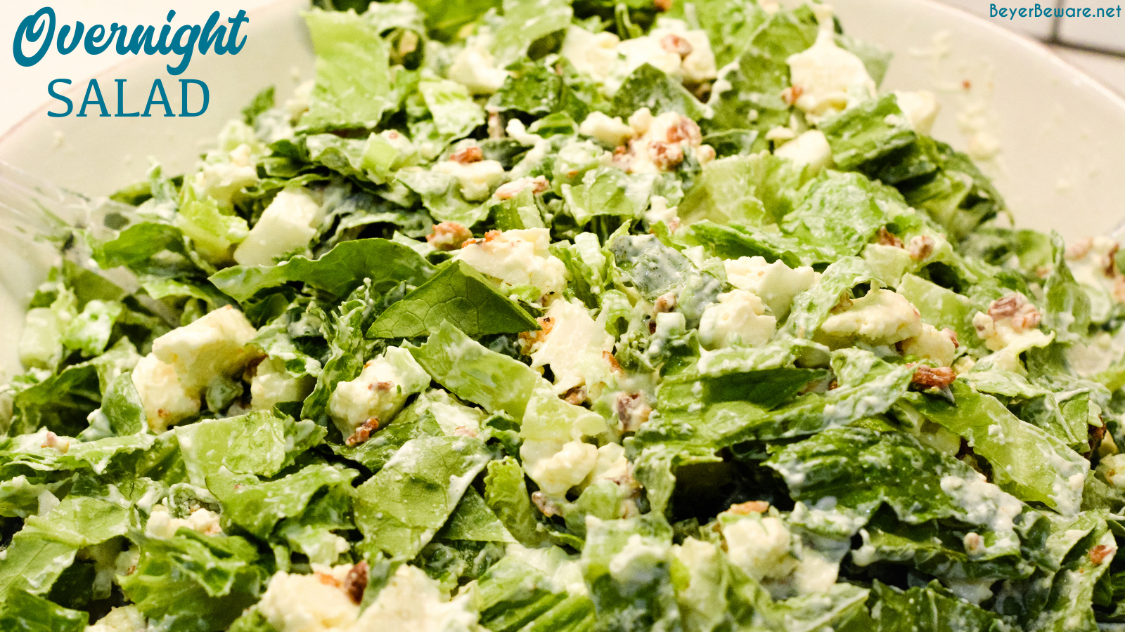 Overnight lettuce salad is my grandmother's version of 7 layer salad made with lettuce, cauliflower, mayonnaise, onions, celery, bacon, and parmesan cheese.