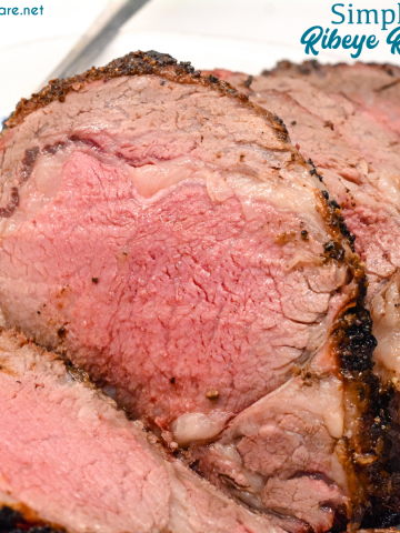 Knowing how to make a ribeye roast can mean a perfect beef holiday dinner entree that is perfectly cooked to a medium rare with a garlic and pepper crust all done on the Big Green Egg grill or the oven.