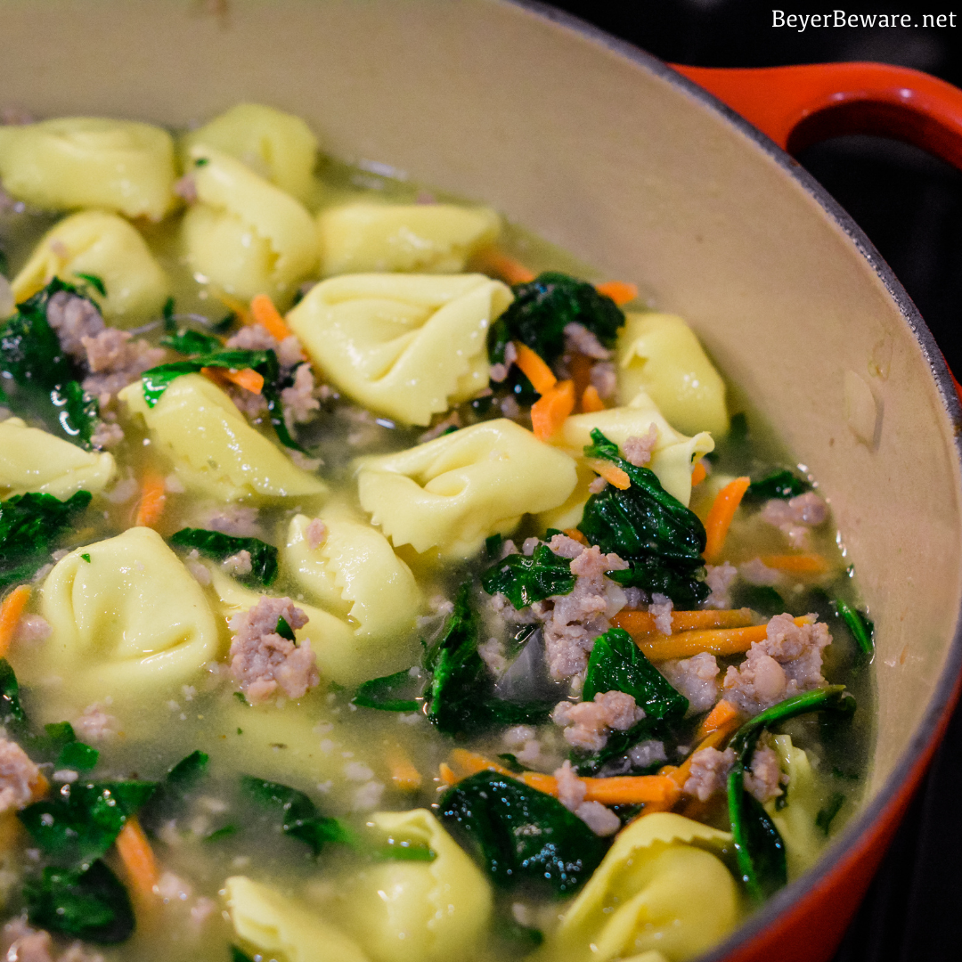 Sausage Tortellini Soup with spinach is a quick soup made on the stove all in one pot for a hearty, creamy soup full of spinach, sausage and cheese tortellini for an Italian sausage tortellini soup.