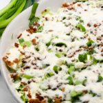 Overnight lettuce salad is my grandmother's version of 7 layer salad made with lettuce, cauliflower, mayonnaise, onions, celery, bacon, and parmesan cheese.