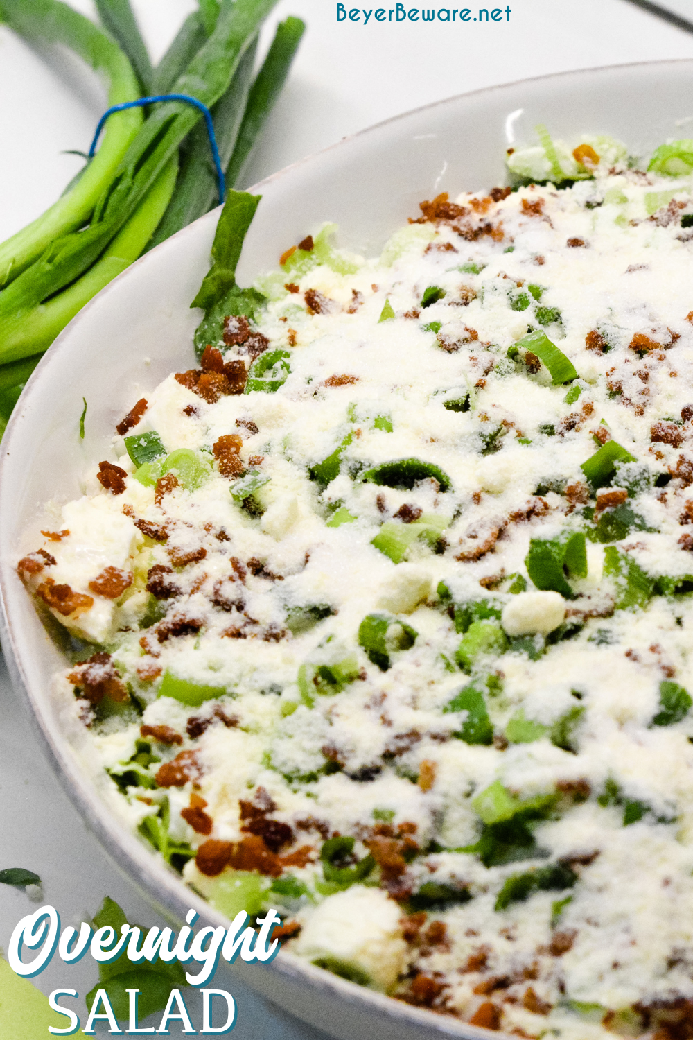 Overnight lettuce salad is my grandmother's version of 7 layer salad made with lettuce, cauliflower, mayonnaise, onions, celery, bacon, and parmesan cheese.