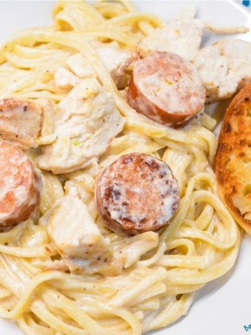 Cajun chicken alfredo with smoked sausage combines air fryer grilled chicken with andouille sausage pan sauteed in a skillet with garlic before being combined with alfredo and a creamy parmesan cajun alfredo sauce.