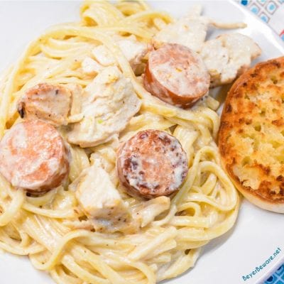 Cajun chicken alfredo with smoked sausage combines air fryer grilled chicken with andouille sausage pan sauteed in a skillet with garlic before being combined with alfredo and a creamy parmesan cajun alfredo sauce.