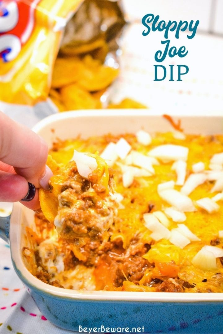 Sloppy Joe Dip has a cream cheese base and topped with an easy sloppy joe ground beef mixture and topped off with shredded cheese and onions, baked to a gooey, meaty goodness and then scooped up with corn chips.