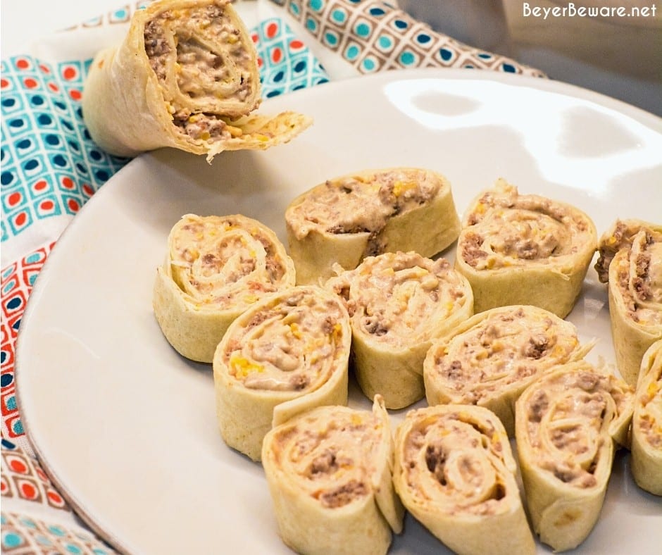 Taco pinwheels are the perfect way to use up leftover taco meat and tortilla shells in a different way than just as tacos again by simply mixing cream cheese, salsa, and taco meat together and spreading over the tortilla shell before rolling up into a pinwheel.