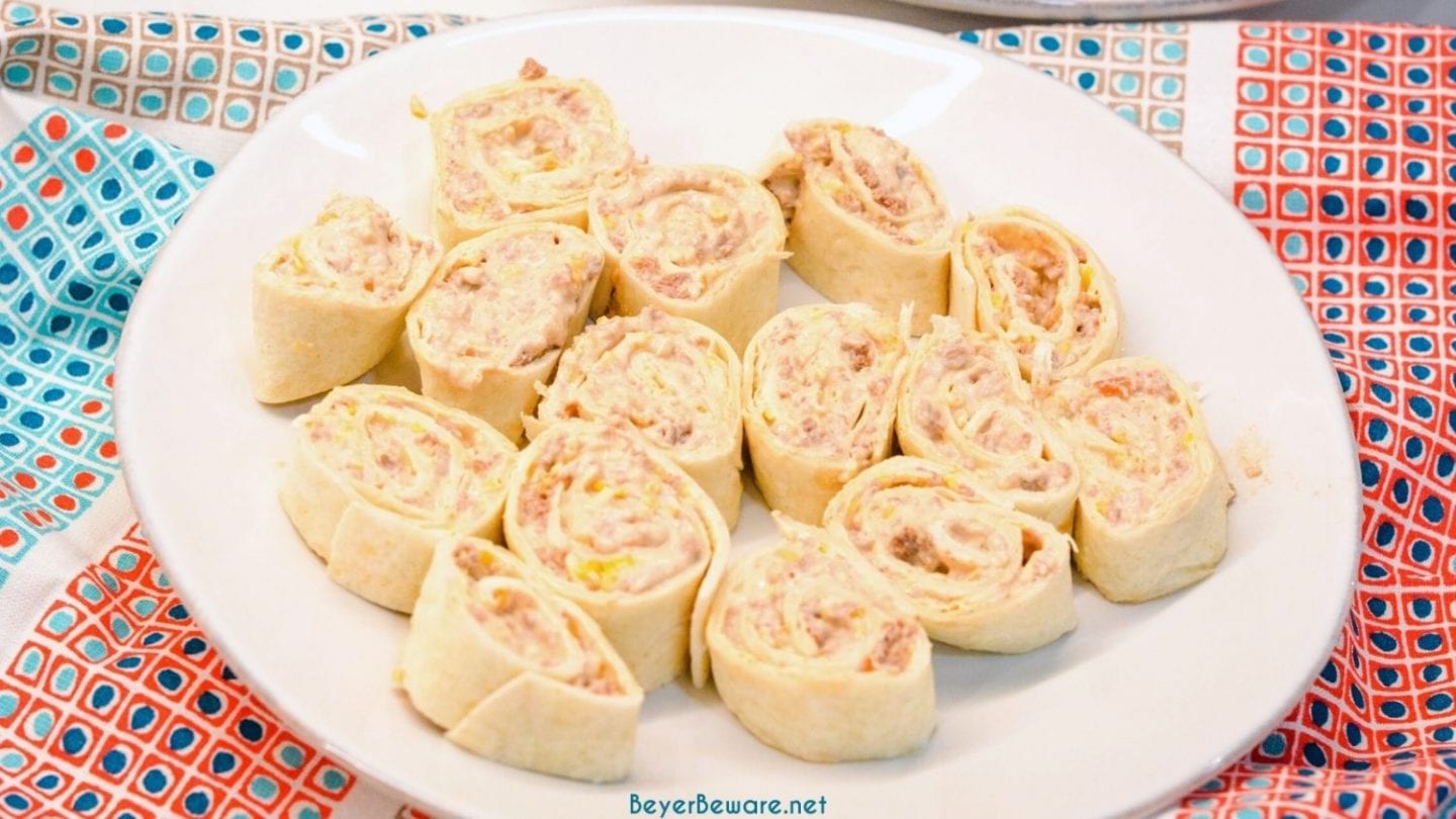 Taco pinwheels are the perfect way to use up leftover taco meat and tortilla shells in a different way than just as tacos again by simply mixing cream cheese, salsa, and taco meat together and spreading over the tortilla shell before rolling up into a pinwheel.