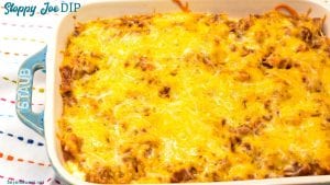 Sloppy Joe Dip has a cream cheese base and topped with an easy sloppy joe ground beef mixture and topped off with shredded cheese and onions, baked to a gooey, meaty goodness and then scooped up with corn chips.