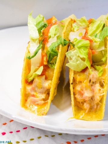 Creamy chicken baked tacos may have just become the best version of baked tacos made quickly with shredded chicken, Rotel, and cream cheese and piled into corn taco shells and baked to cheesy perfection.