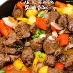 Garlic pepper steak bites recipe is an easy cast iron steak skillet meal made with an easy marinated sirloin steak recipe, garlic, onions, and bell peppers served over mashed potatoes or rice.