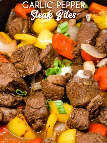 Garlic pepper steak bites recipe is an easy cast iron steak skillet meal made with an easy marinated sirloin steak recipe, garlic, onions, and bell peppers served over mashed potatoes or rice.