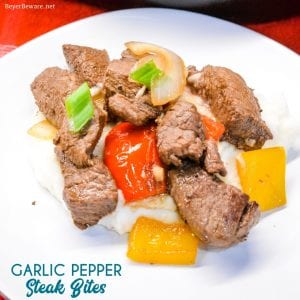 Garlic pepper steak bites recipe is an easy cast iron steak skillet meal made with an easy marinated sirloin steak recipe, garlic, onions, and bell peppers served over mashed potatoes or rice.