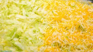 Lettuce and shredded cheese layer of the 7 layer dip.