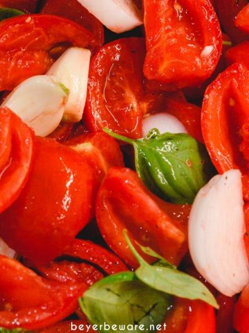 Tomato basil sauce is easy to make by oven roasting the tomatoes, garlic, onions, basil, and olive oil before pureeing into the sauce.