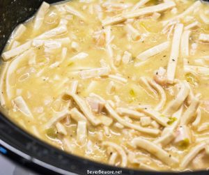 Easy Crock Pot Chicken and Noodles is made by slow cooking chicken, onions, celery, and garlic all day and then adding Reames wide noodles.