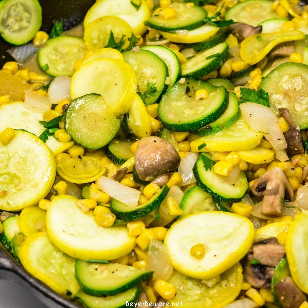 Skillet zucchini and summer squash recipe with corn and mushrooms is a quick sauteed squash recipe that comes together with lots of flavors thanks to onions, garlic, and fresh herbs.