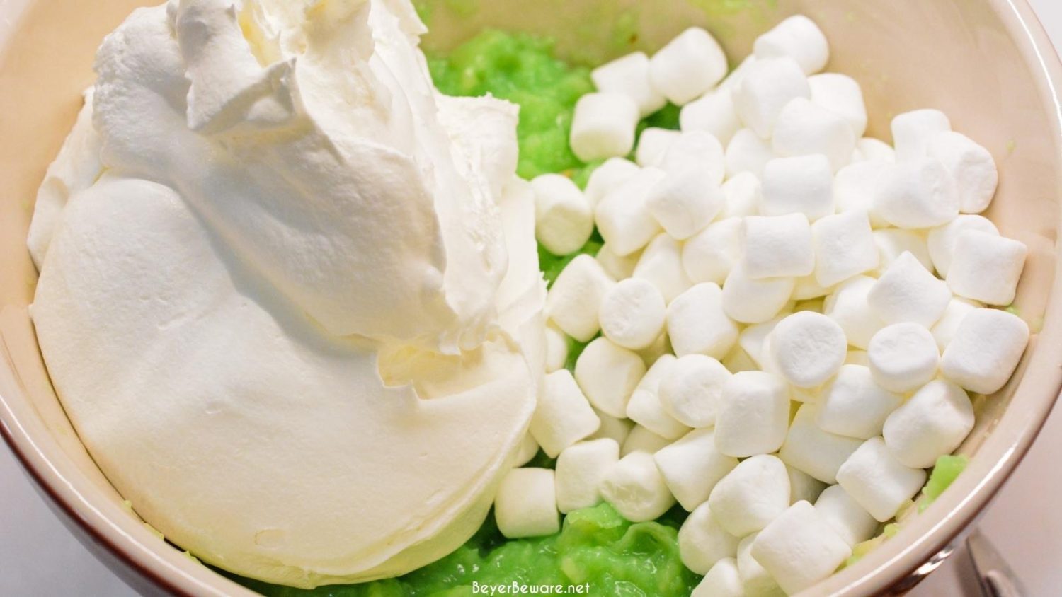 Watergate Salad is a simple 5-ingredient recipe made with instant pistachio pudding, pineapple, marshmallows, cool whip, and nuts. Want the pistachio fluff salad instead? Just leave the nuts out!