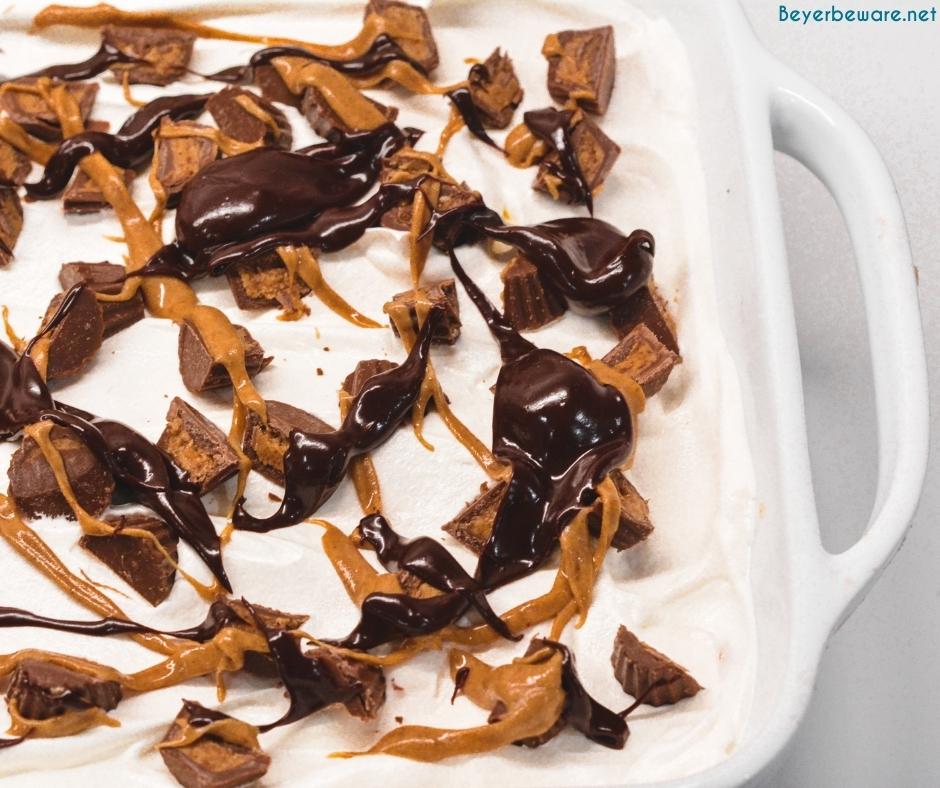 Finally, top off the cool whip of the peanut butter pie with chopped up peanut butter cups, melted chocolate and melted peanut butter. Add a dap of crisco to the chocolate to help it spread better. Just use spoonfuls of both to drizzle over the top.