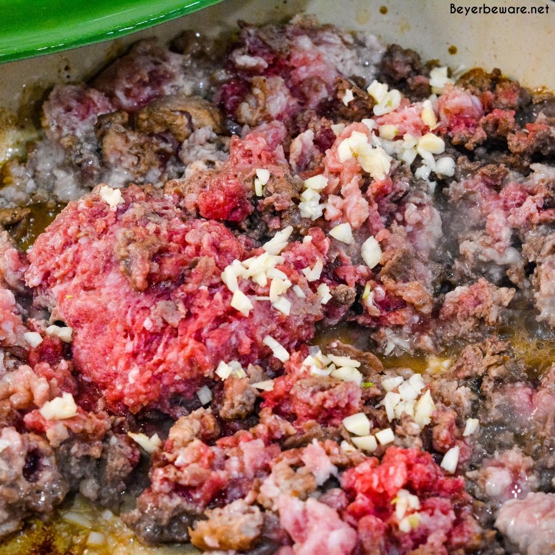 Browning ground meat with garlic and seasonings.