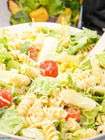Caesar Pasta Salad is a great side salad or base for grilled chicken or salmon and is easily put together with romaine lettuce, pasta, cherry tomatoes, parmesan cheese, croutons, and Caesar salad dressing. 