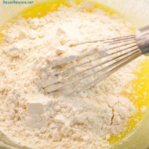 stirring dry ingredients into wet ingredients for lemon zucchini bread