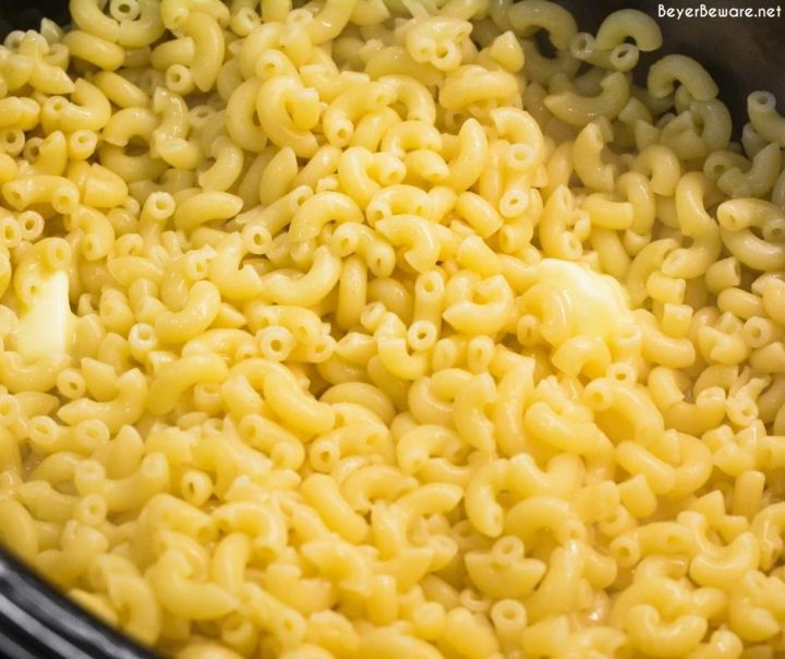 Cooked pasta with butter in a crock pot for crock pot macaroni and cheese