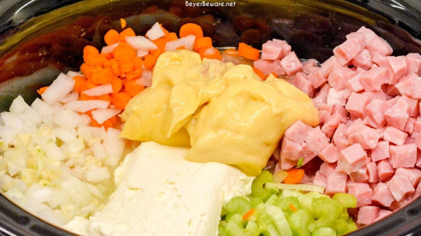 In the crock pot, dump the potatoes, ham, vegetables, soup, broth, and cream cheese