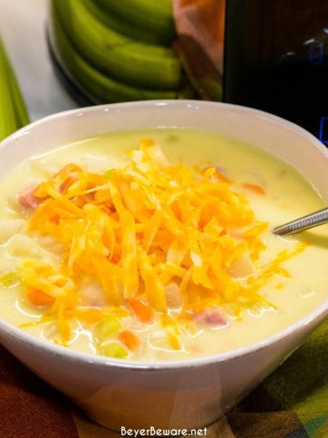 Crock pot ham and potato soup is slow-cooked all day in a base of carrots, celery, onions, and garlic along with diced potato hash browns, ham, and cream cheese to make a hearty soup dinner.