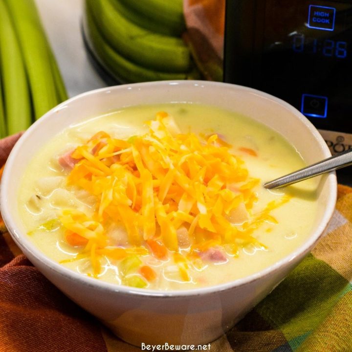 Crock pot ham and potato soup is slow-cooked all day in a base of carrots, celery, onions, and garlic along with diced potato hash browns, ham, and cream cheese to make a hearty soup dinner.