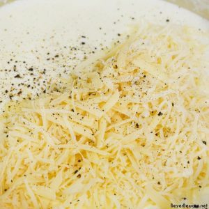 Add the shredded parmesan cheese, salt, and pepper. Continue stirring until melted.