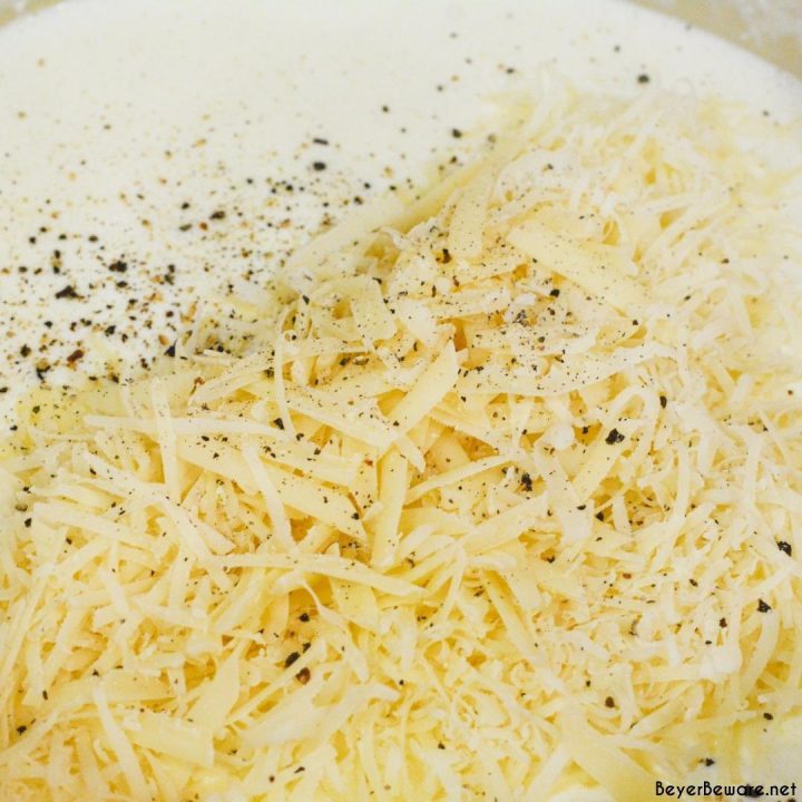 Add the shredded parmesan cheese, salt, and pepper. Continue stirring until melted.