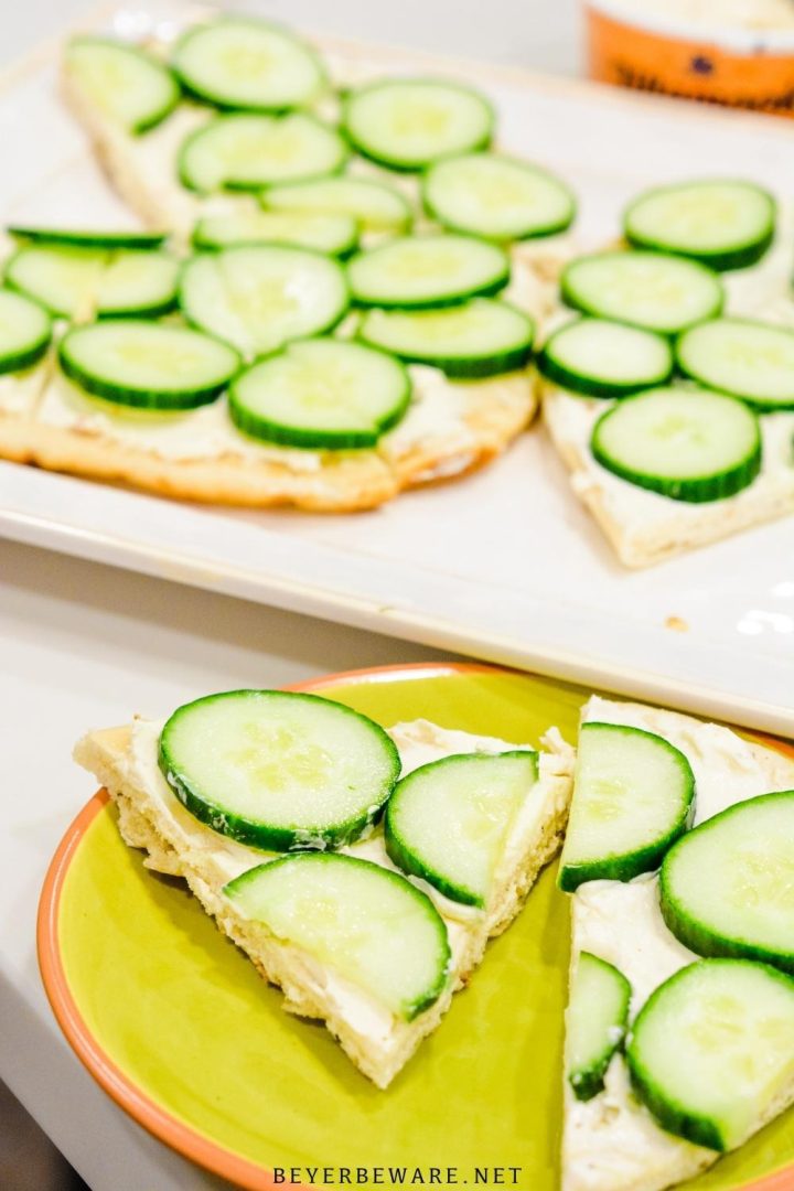 Cucumber pizza is a simple no-bake appetizer made with naan bread, cream cheese, Italian seasoning, and cucumbers cut into cucumber bites.