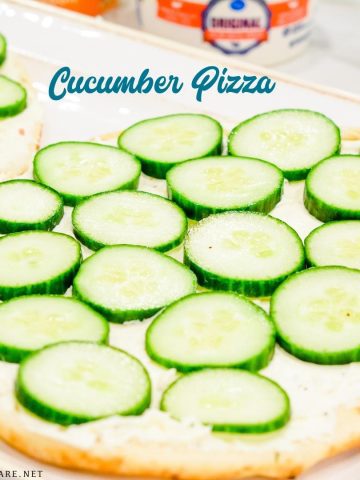 Cucumber pizza is a simple no-bake appetizer made with naan bread, cream cheese, Italian seasoning, and cucumbers cut into cucumber bites.