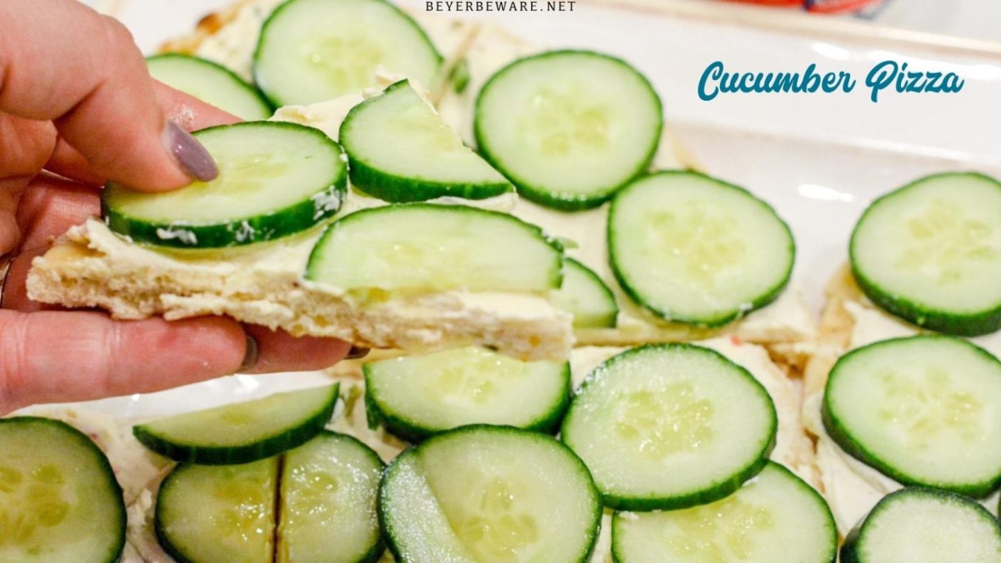 Cucumber pizza is a simple no-bake appetizer made with naan bread, cream cheese, Italian seasoning, and cucumbers cut into cucumber bites.