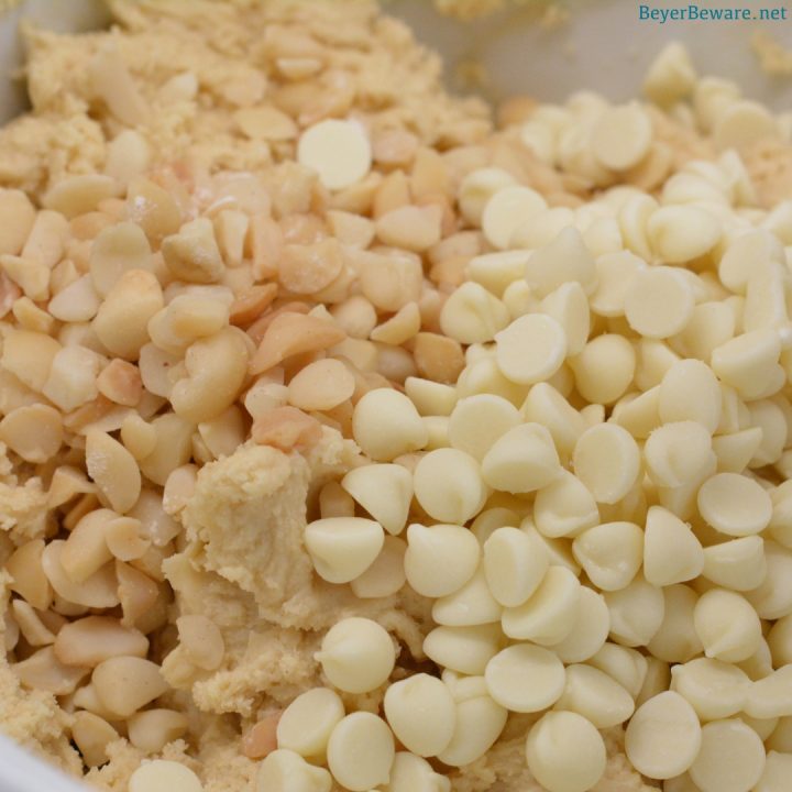 Stir in the white chocolate chips and macadamia nuts into the cookie dough.