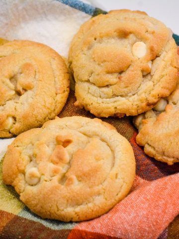 The softest white chocolate macadamia nut cookies you will make have butter, shortening, white chocolate chips, and instant pudding in them.