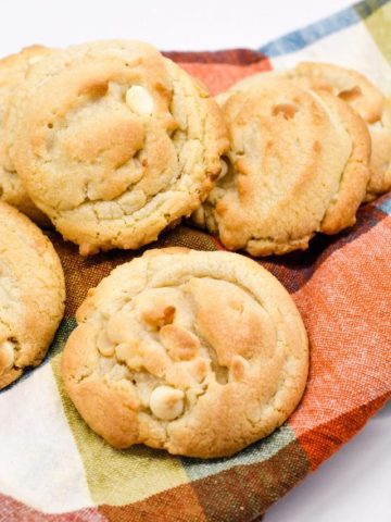 The softest white chocolate macadamia nut cookies you will make have butter, shortening, white chocolate chips, and instant pudding in them.