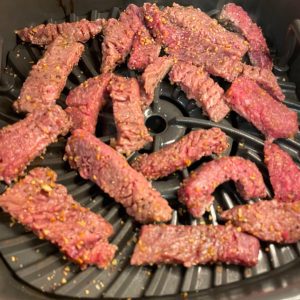 In a preheated air fryer, spray the grill grate with cooking spray and lay the steak fingers in the air fryer. Flip after cooking for 3-4 minutes.