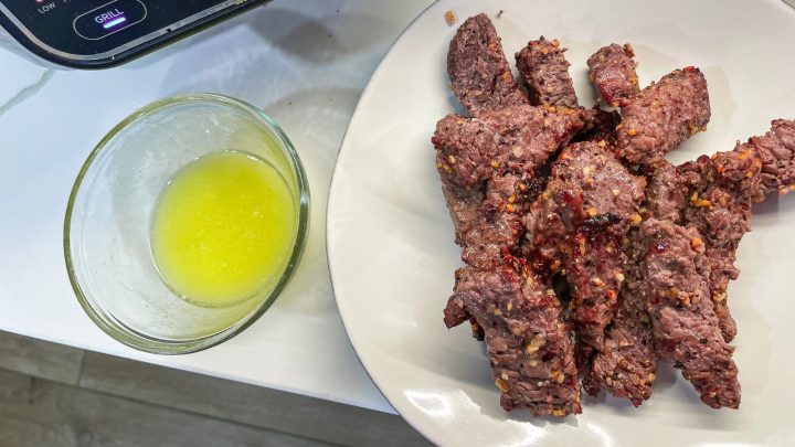 While the steak is frying, mince garlic and melt butter to make garlic butter for dipping the steak fingers in.