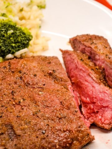 Air fryer steak is easily made with a simple steak seasoning and 8 minutes in the air fryer gets you a perfectly cooked medium rare steak with a top off of some butter for an easy way to have steak on a weeknight.