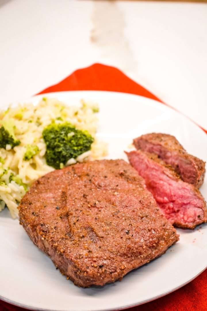 Air fryer steak is easily made with a simple steak seasoning and 8 minutes in the air fryer gets you a perfectly cooked medium rare steak with a top off of some butter for an easy way to have steak on a weeknight.
