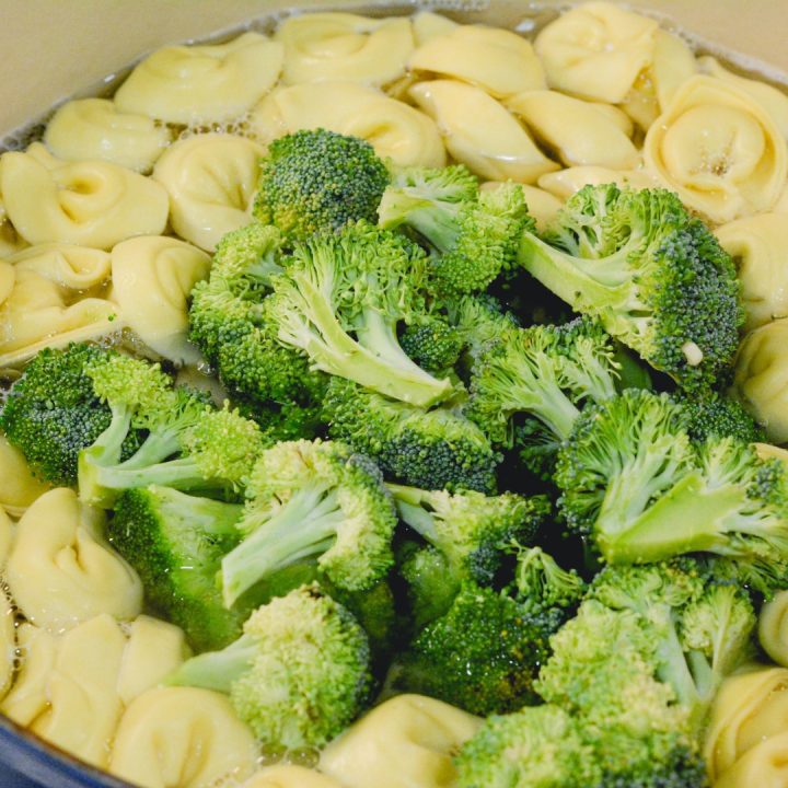 Boil water to cook the cheese tortellini and broccoli florets in. Reserve a cup of water when the tortellini is done cooking.
