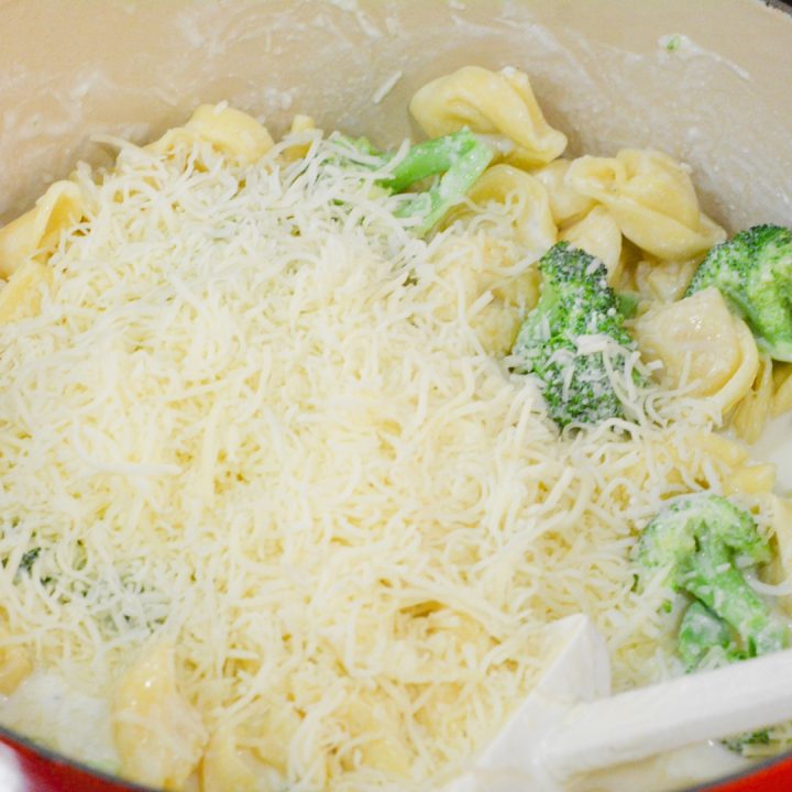 Drain the tortellini and broccoli and add them to the alfredo sauce along with the shredded cheese. Add reserved water from cooking pasta to pot if more liquid is needed.