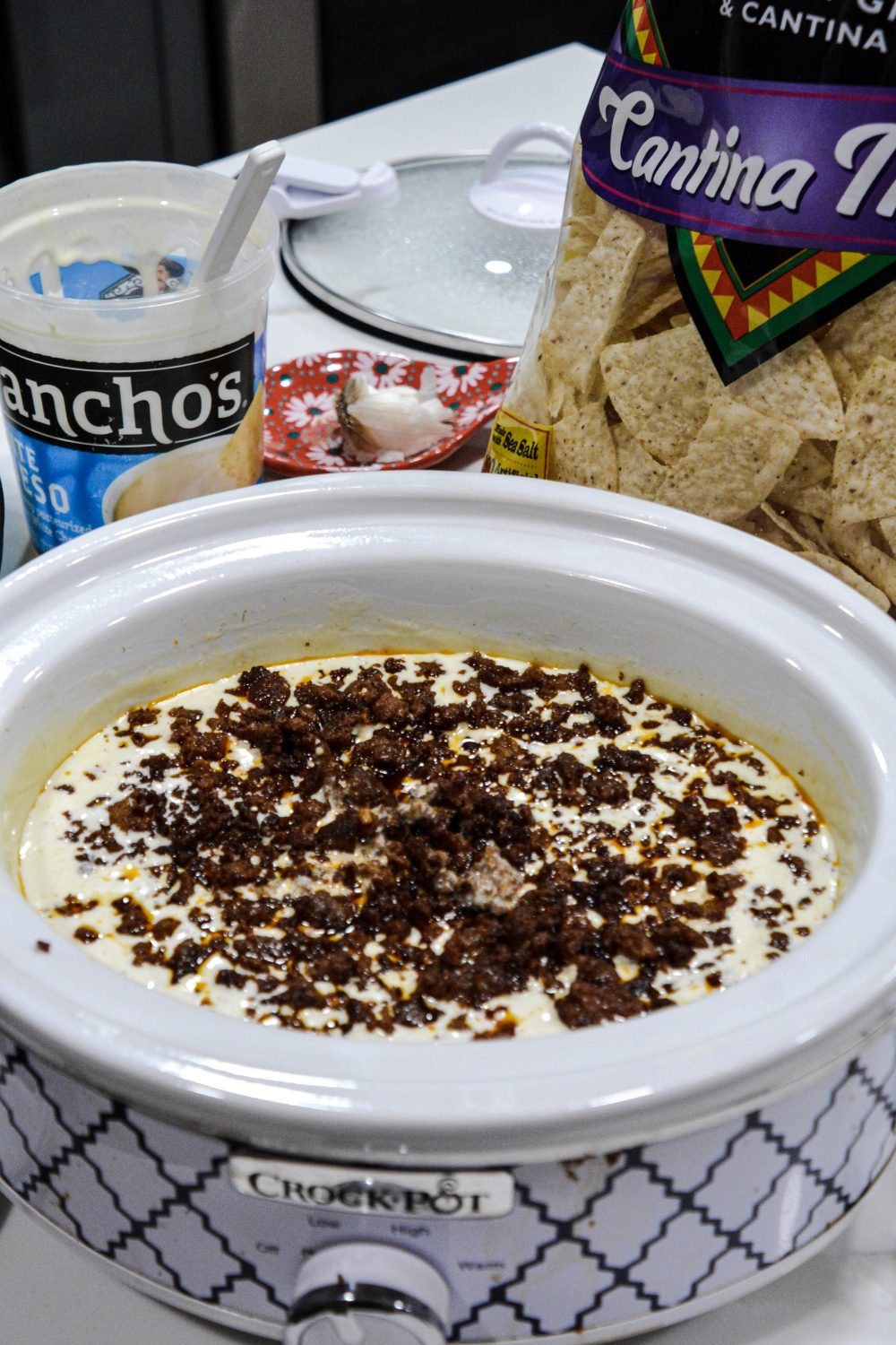 A vegetarian queso can be made by omitting the chorizo. Add the green
